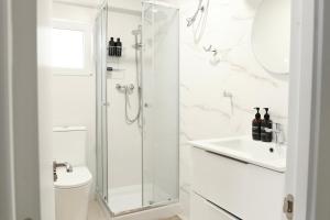 a bathroom with a shower and a toilet and a sink at Apartment with sea view in Cullera in Faro de Cullera