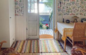an open door to a room with a table and a window at Beautiful Home In Tranås With Lake View in Tranås
