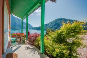 a house with a view of the water and mountains at B&B Ca' Serena wine retreat in Ledro