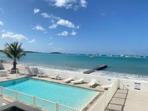 a swimming pool with a view of the ocean at Sea view Marigot pool studio in Saint Martin