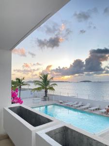 a swimming pool with a view of the ocean at Sea view Marigot pool studio in Saint Martin