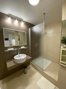 a bathroom with a sink and a shower at Sea view Marigot pool studio in Saint Martin