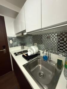 a kitchen with a sink and a counter top at StayAire by A&R in Sampong +17 photos