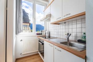a kitchen with a sink and a window at Living Eden by we rent in Zell am See