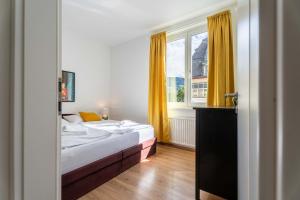 a bedroom with two beds and a window at Living Eden by we rent in Zell am See