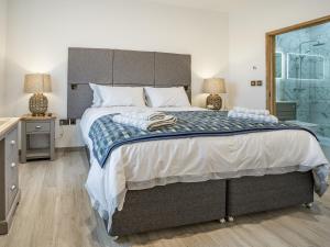 ein Schlafzimmer mit großem Bett und Fenster in der Unterkunft Copper Beech Cottage - Uk35892 in Ludchurch + 15 Fotos