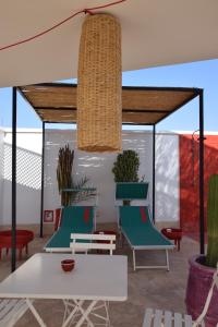 a patio with chairs and a table and a ceiling at Miostello Lifestyle Riad Marrakech in Marrakech