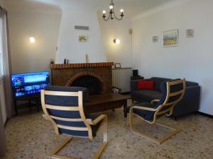 a living room with two chairs and a fireplace at La campagne in Cuers