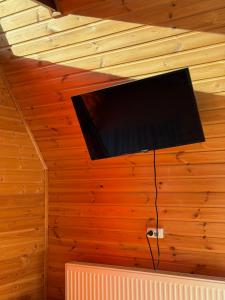 a flat screen tv hanging from the ceiling of a room at Kazbegi Kuro Cottages in Kazbegi