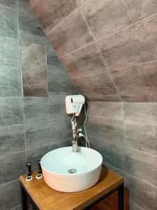 a bathroom with a white sink on a wooden table at Kazbegi Kuro Cottages in Kazbegi +73 photos