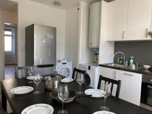 a kitchen with a table with wine glasses on it at City Centre Saint-Louis in Saint-Louis