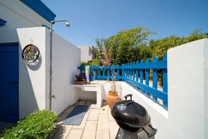 a black pot sitting on the side of a fence at My sweet Greek dream - Traditional home in Soroni +22 photos