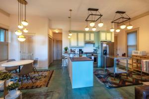 an open kitchen and living room with tables and chairs at Roe Parker House in Hood River