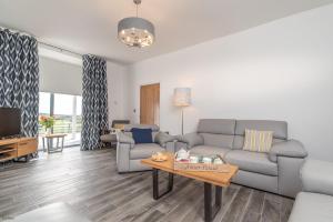 a living room with a couch and a table at Bryndeusant in Llanbabo