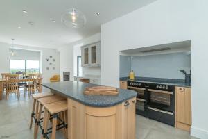 a kitchen with a counter and a stove top oven at Bryndeusant in Llanbabo