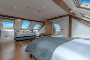 a bedroom with a large bed and windows at Bryndeusant in Llanbabo +32 photos