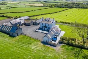 an aerial view of a large house in a field at Bryndeusant in Llanbabo
