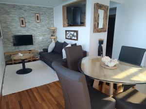 a living room with a couch and a table at CLEMARA EVASION in Schœlcher