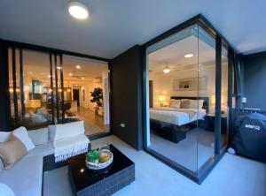a bedroom with a bed and a large glass wall at Luxe Retreat in Brisbane +10 photos