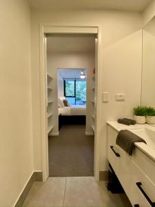 a hallway leading to a bedroom with a bed at Luxe Retreat in Brisbane