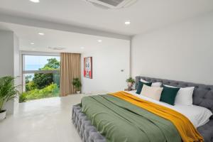 a bedroom with a large bed with a large window at Villa Ann - Contemporary Private Pool Villa near Chaweng Noi Beach in Koh Samui  +12 photos