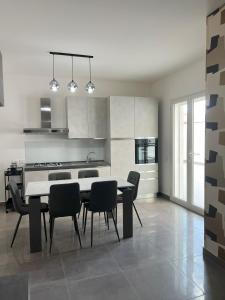 a kitchen with a table and chairs in a room at Casa Dea in Paterno