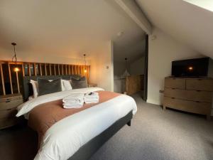 a bedroom with a large bed and a television at White Cairn - Uk50484 in Kylestrome +17 photos