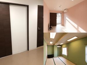 a room with green and white walls and a door at Hotel Roots in Shirahama
