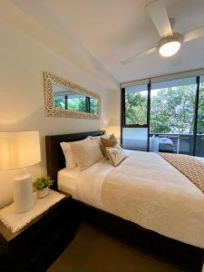 a bedroom with a bed and a ceiling fan at Luxe Retreat in Brisbane