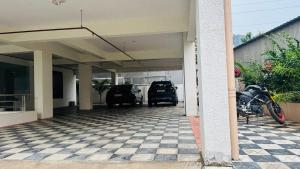 a parking lot with a motorcycle parked in a garage at Hotel Maski Suties in Kondapur