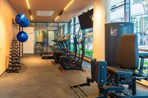 a gym with treadmills and exercise equipment in a building at CGB302 - Apto com piscina e academia Bela Vista in Sao Paulo