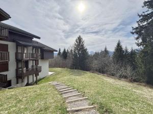 un cortile erboso con gradini che conducono a una casa di Appartement 3 pièces pour 5 pers. à Crest-Voland, classé 3 étoiles, proche piste et commerces - FR-1-595-70 a Crest-Voland