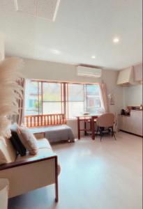 a bedroom with a bed and a dining room with a table at 伊勢神宮内宮前-民泊宿i s e s h i m a -205 in Ise