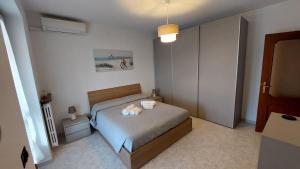 a bedroom with a bed with two stuffed animals on it at A casa di Gina in Airasca