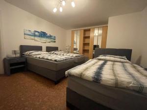 two beds in a room with two beds sidx sidx sidx at Karos-Apartment in Mittersill
