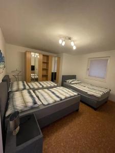 a bedroom with two beds and a mirror at Karos-Apartment in Mittersill