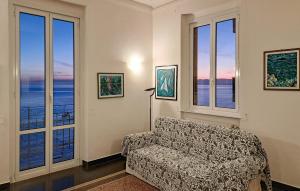a living room with a couch and windows at 4 Bedroom Lovely Apartment In Camogli in Camogli +29 photos