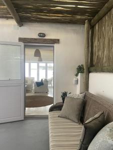 a living room with a couch and a sliding glass door at Bougain Villa in Paternoster