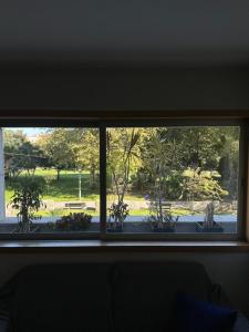 a window with a view of a park seen through it at Luxury apartment in Espinho