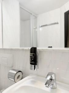 a white bathroom with a sink and a mirror at Colour Hotel in Frankfurt +18 photos