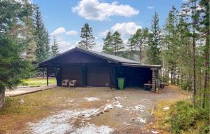 a brown building with two chairs in front of it at Nice Home In Kälarne With Sauna in Övsjöbyn +30 photos