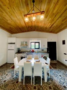 a kitchen with a white table and white chairs at Kent Villas in Demre