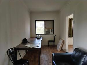 a small room with a desk and a window at Kent st Hostel in Rockhampton
