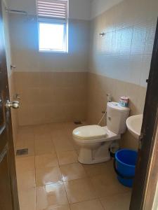 a bathroom with a toilet and a sink at Time and Spenser Apartment ,condo in Wellawatta