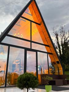 a triangle shaped building with a large window at Utopia Inn უტოპია ინნ in Batumi