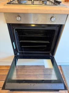 an oven with its door open in a kitchen at 5 Brunswick - room 04 in Bristol +3 photos