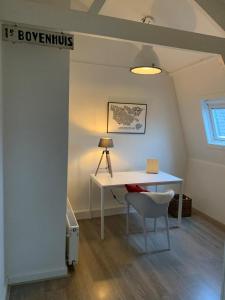 a white desk with a chair in a room at Abcoude city center in Abcoude