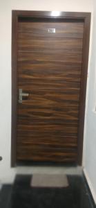 a wooden door with the number on it at Arora golden guest house in Amritsar