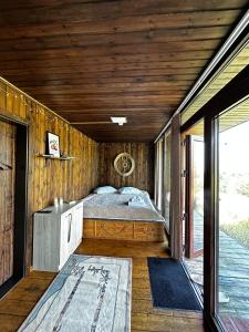 a bedroom with a bed in a wooden room at Almaty Hills VIP House in Almaty