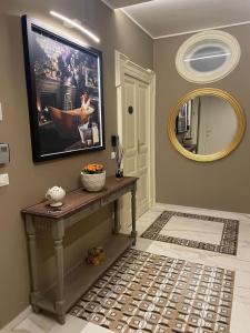 a living room with a large mirror and a table at Maison MoDì in Taranto